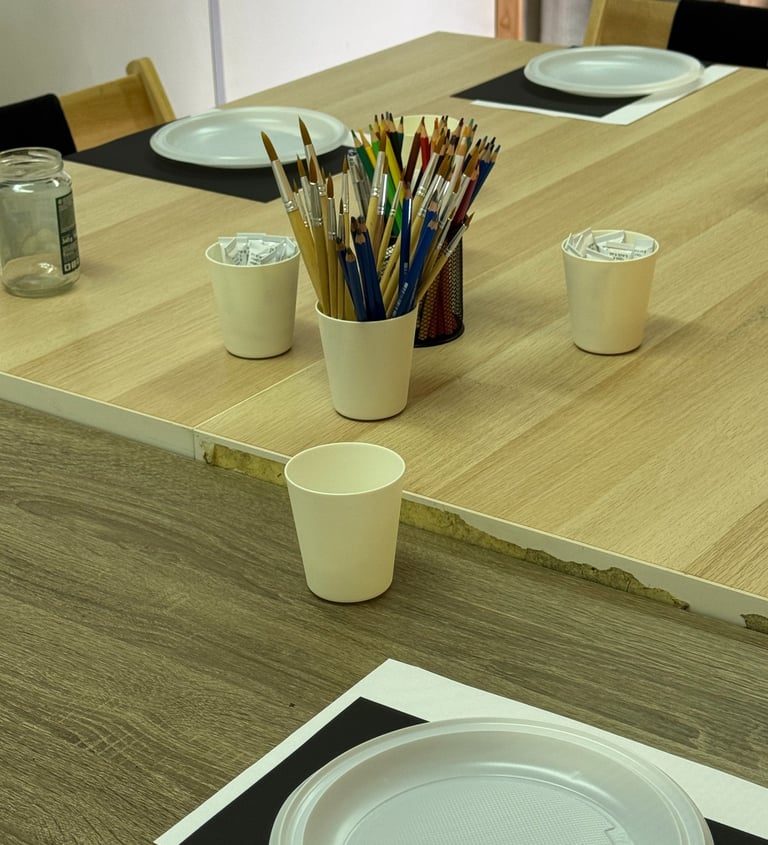 Painting workshop materials and tables in Lisbon studio