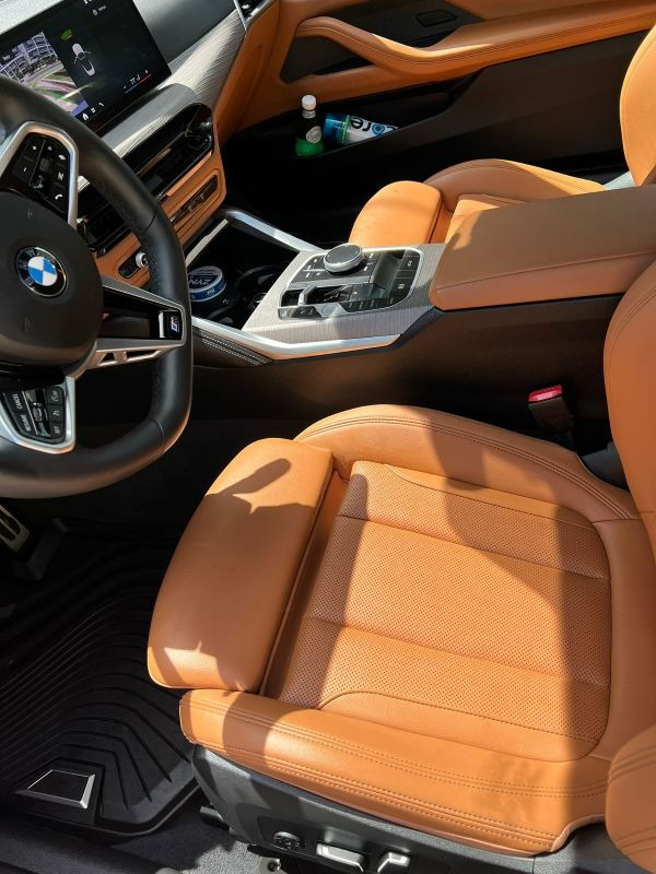 Close-up of clean luxury leather seat and center console after professional interior car detailing