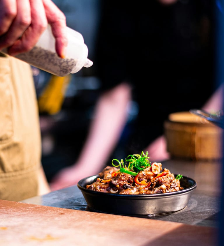 chef is pouring sauce over a delicious looking oven dish ready to be served