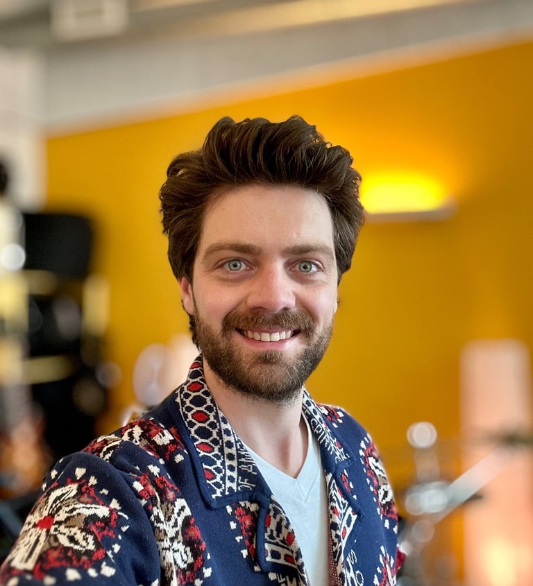 a man with a beard and a beard wearing a blue shirt