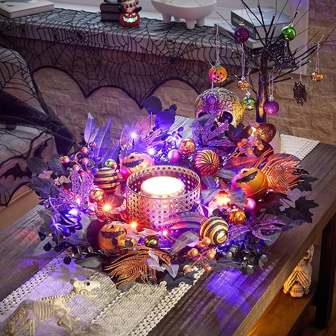 Halloween centerpiece featuring a glowing candle surrounded by purple and orange lights, artificial 