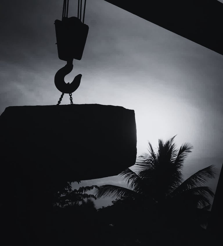 crane lifting granite block