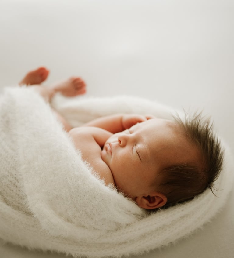 newborn baby peacefully sleeping, captured during a natural light newborn photography session