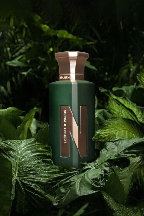 a bottle of Naseem Lost in the Wood perfume on a green leafy background