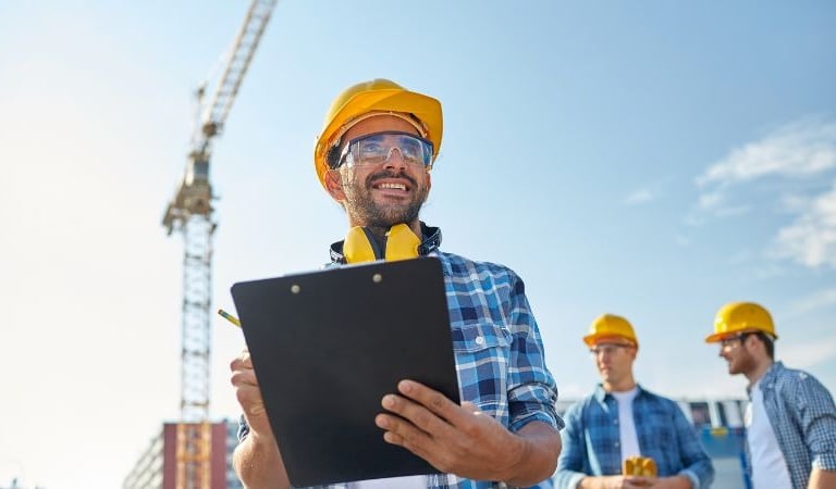 a man in a hard hat and safety vest