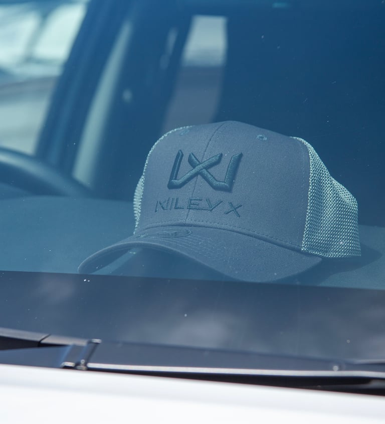 Wiley X Hat in the front of a car