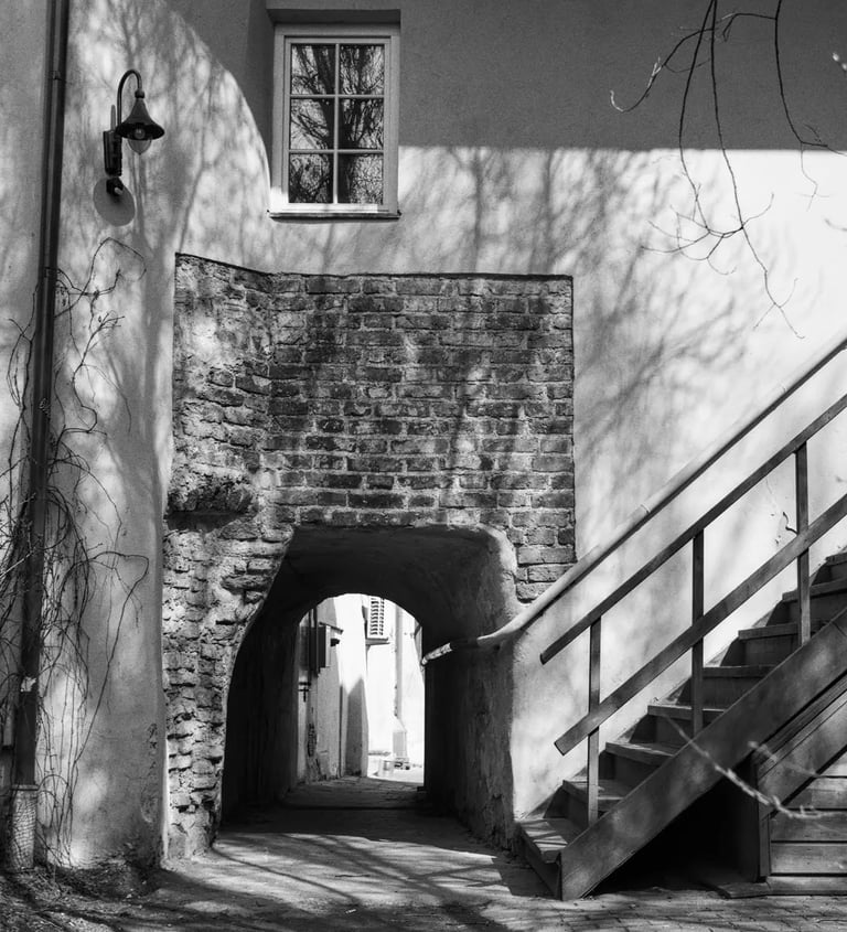 An aged brick building with an exterior stairway