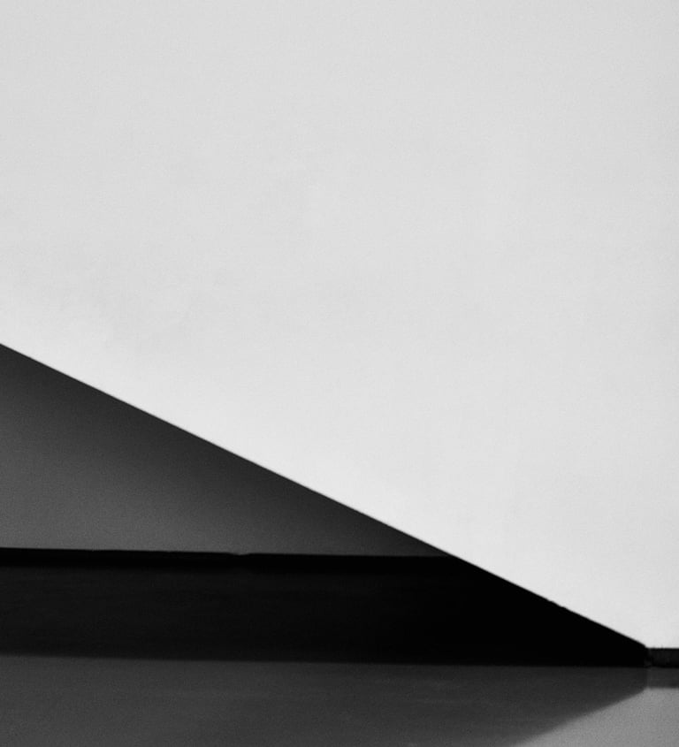 A staircase and wall captured in black and white colors