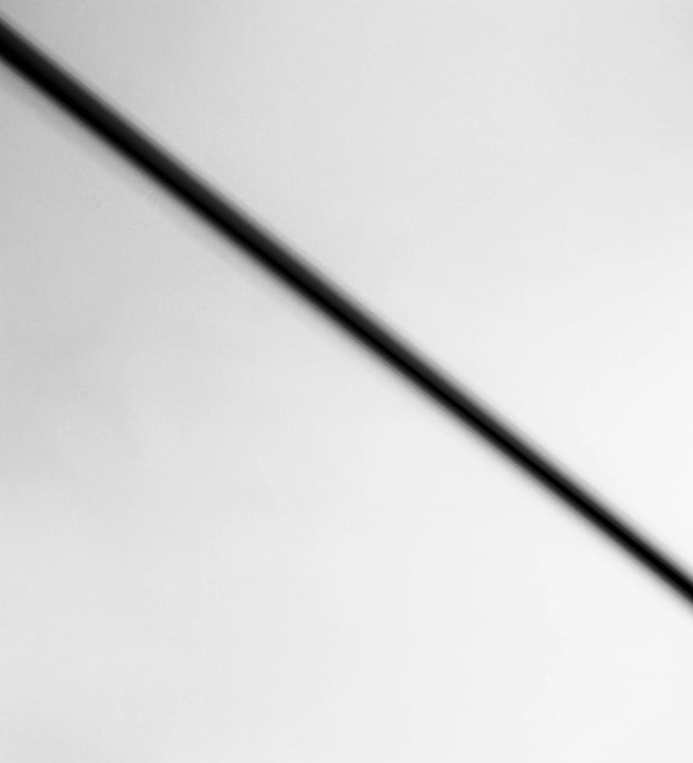 A monochrome image of a street sign, devoid of color, captured in black and white.