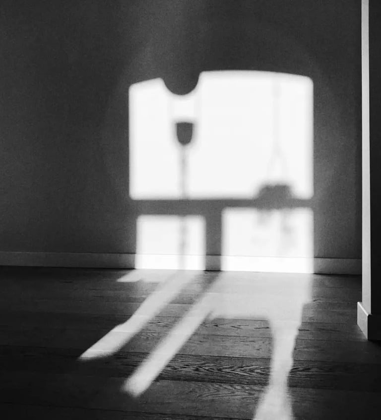 Black and white photograph of window shadow on the wall