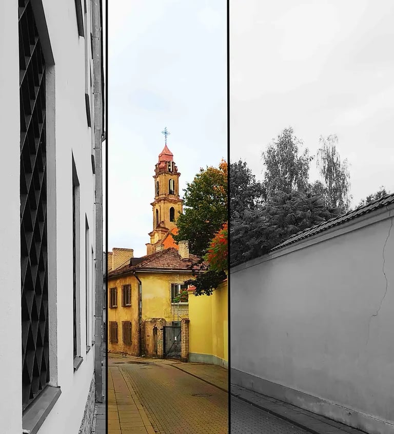 Narrow street picture with a church tower in the background
