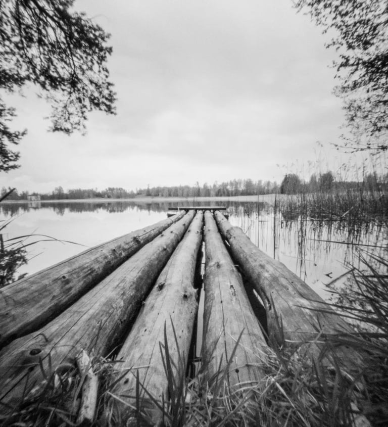 A monochrome image of a wooden dock, showcasing its rustic charm and simplicity