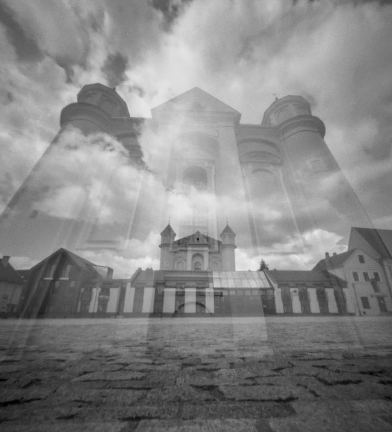 Double exposure of a black and white church against a sky backdrop