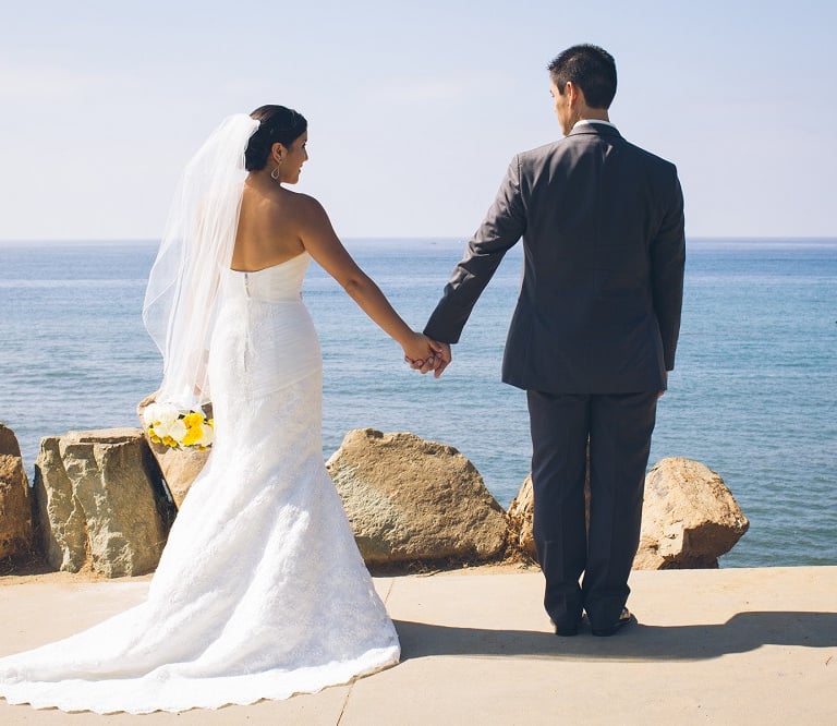 bride and groom holding hands at Calumet Park, la jolla,