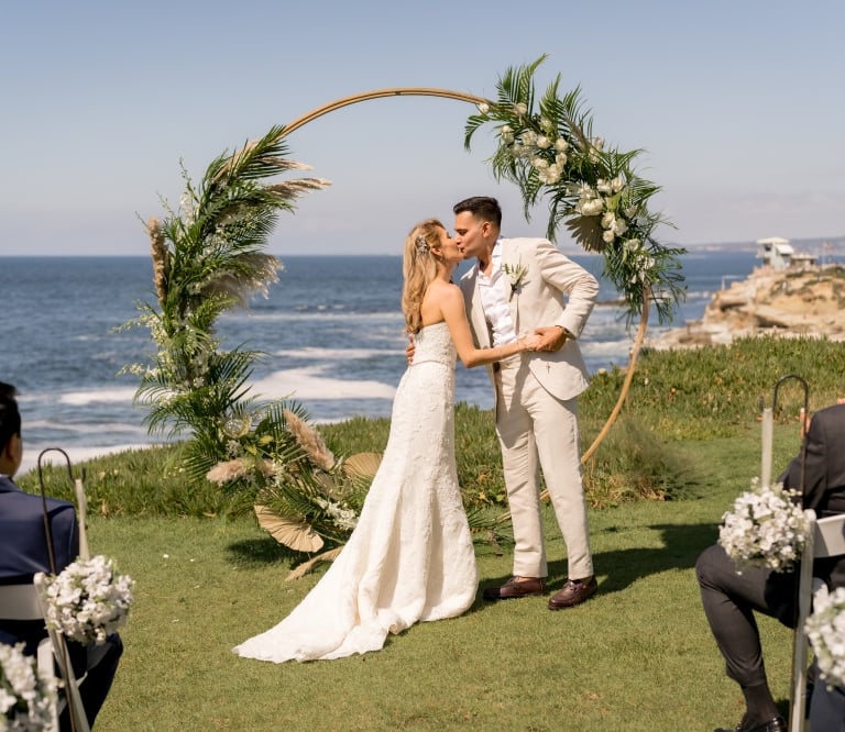 couple kissing at wedding ceremony at Cuvier Park, the wedding bowl, La Jolla