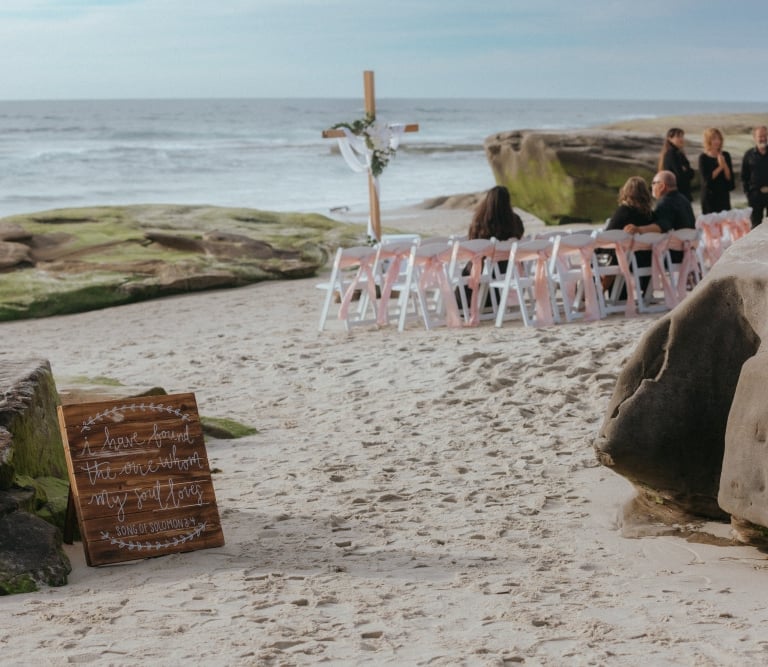 wedding set up on the sand at Windansea Beach la jolla, with cross altar