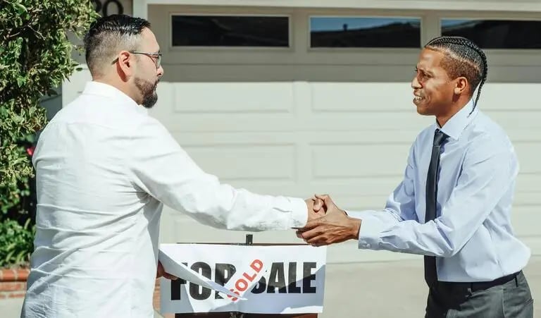 Two professionals closing a deal representing local market execution and on-ground support