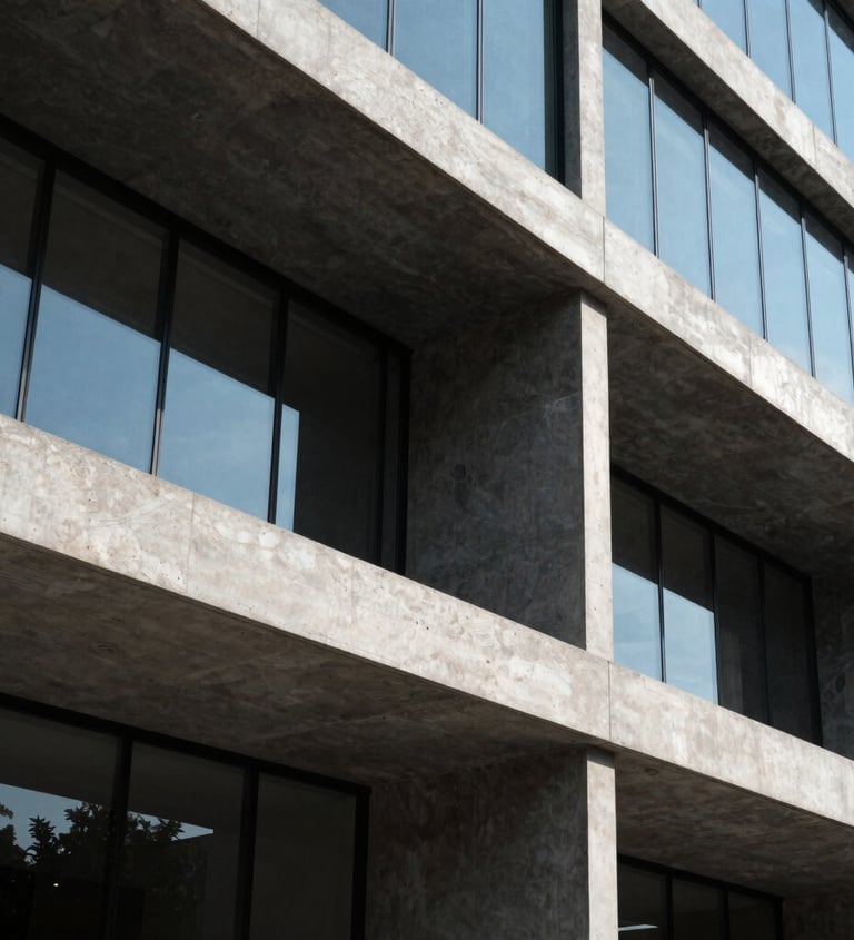 Exterior architectural photograph of a modern commercial building facade in Mexico / Latin America. Crisp geometric concrete beams, dark charcoal panels, and sleek glass reflections captured in bright daylight.