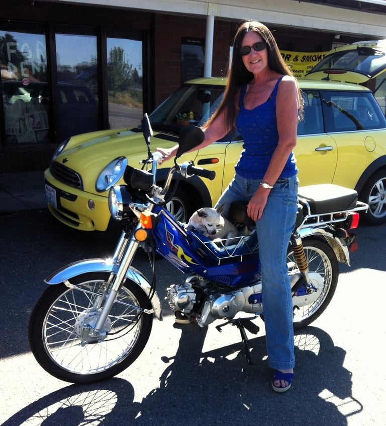 woman on moped with dog
