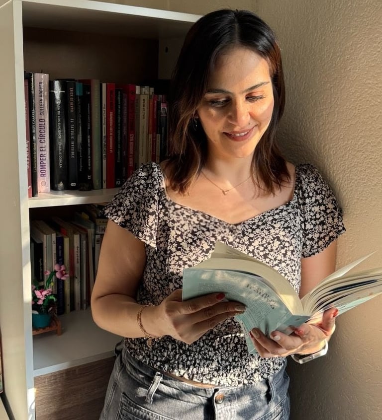 a woman is standing in front of a bookcase