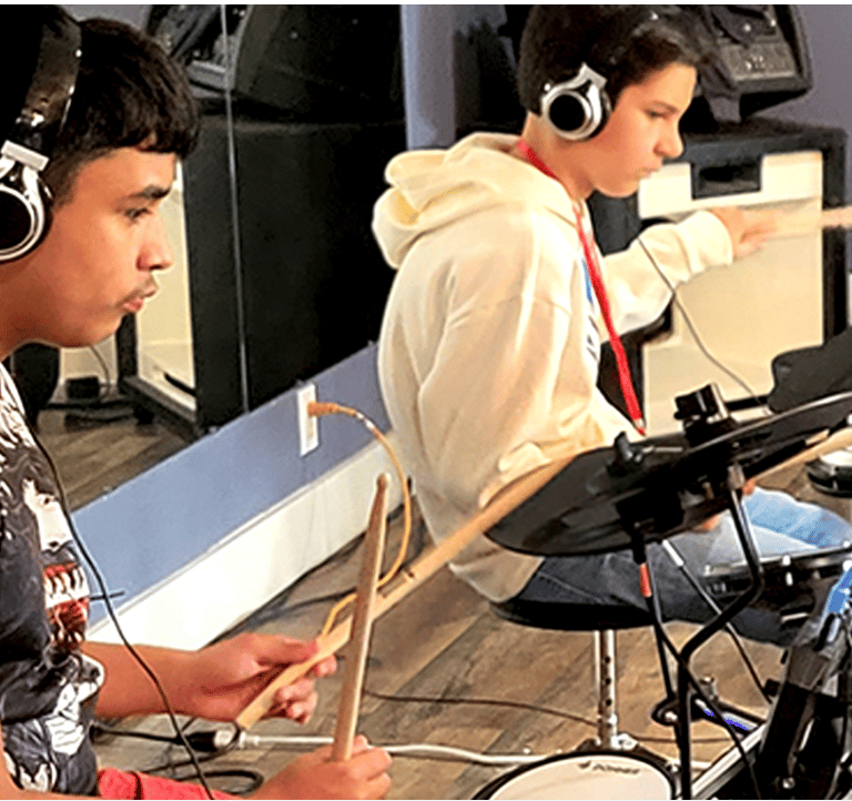 Teens drumming on electric drums