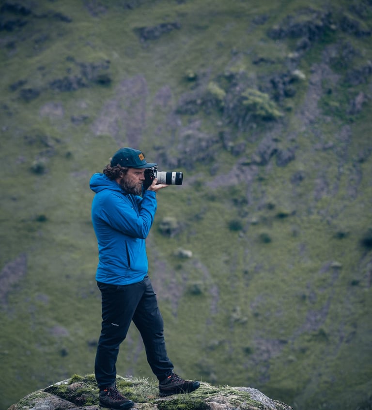a photo of mike brogden taking photos on a mountain