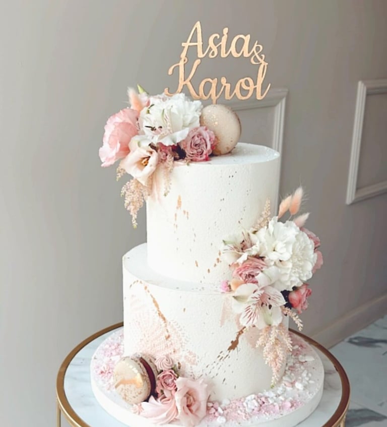a white cake with a gold cake topperf