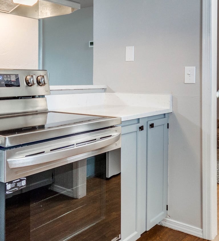 a modern kitchen with stainless steel stove and fresh paint