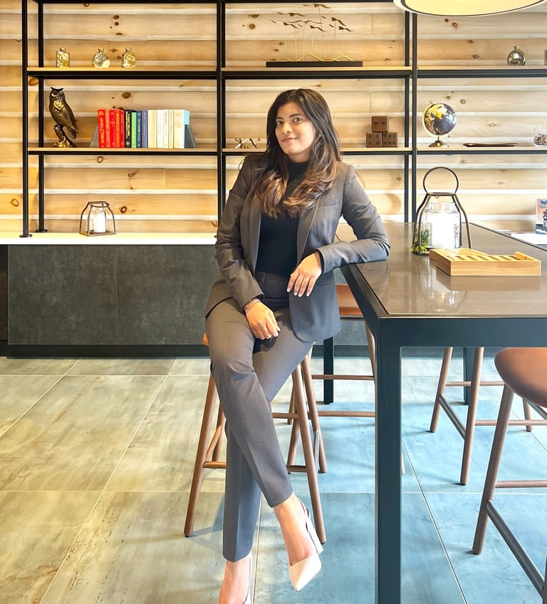 a woman sitting at a table with a lamp on it