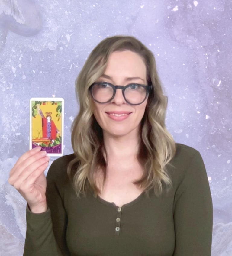 Natalie Grace, founder of Crystal aura Tarot, holding The Magician Card with amethyst background