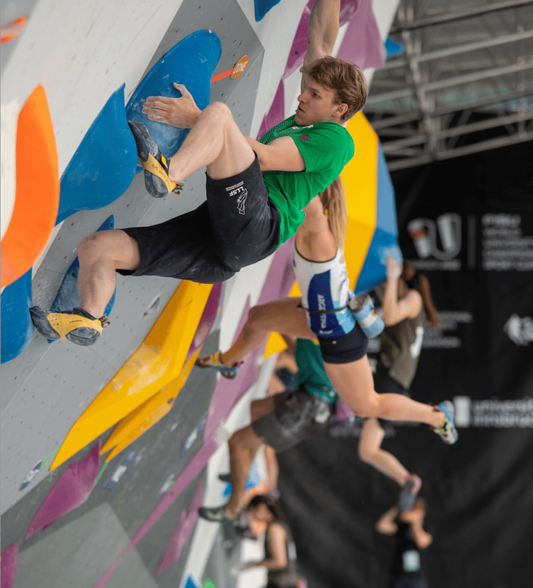 people bouldering in a competition