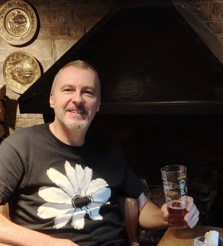 Author Jon Clynch by a cosy open fireplace in an ancient English public house.