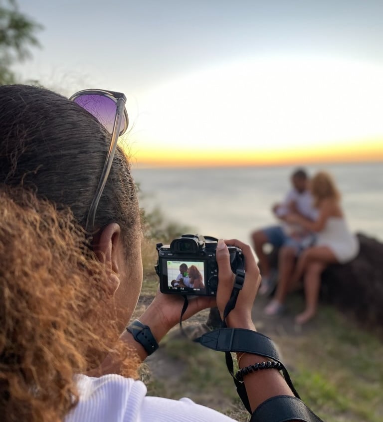 a woman taking a picture of a man and woman
