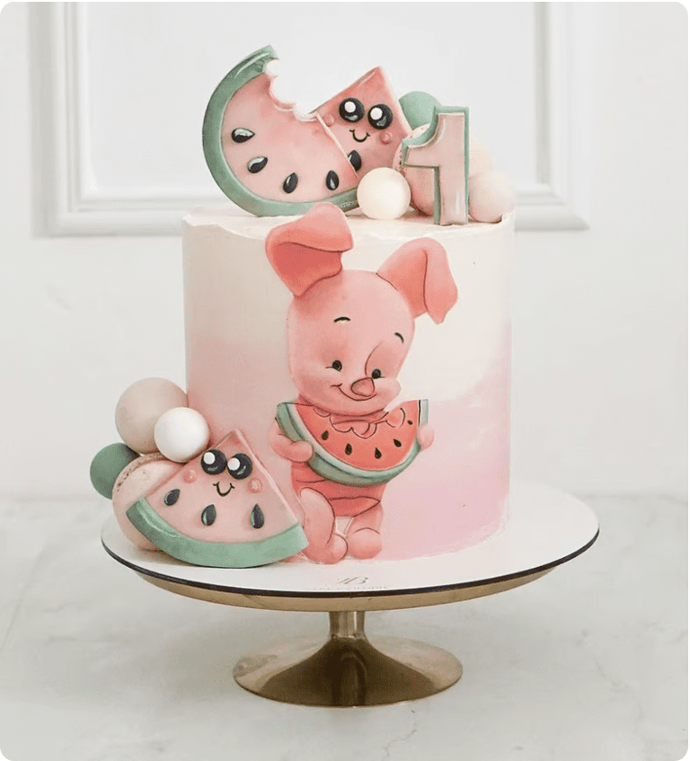 a cake with a piggy and a watermelon