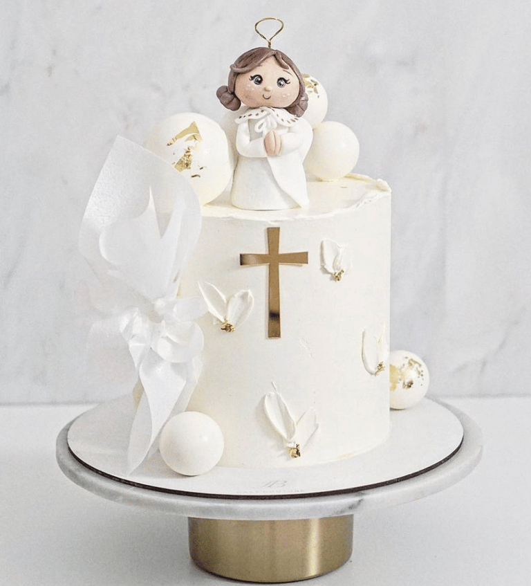 a cake with a little angel on top of it