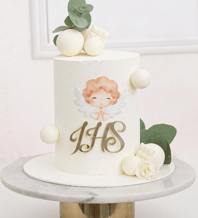 a cake with a white cake topperf and a gold cupcake