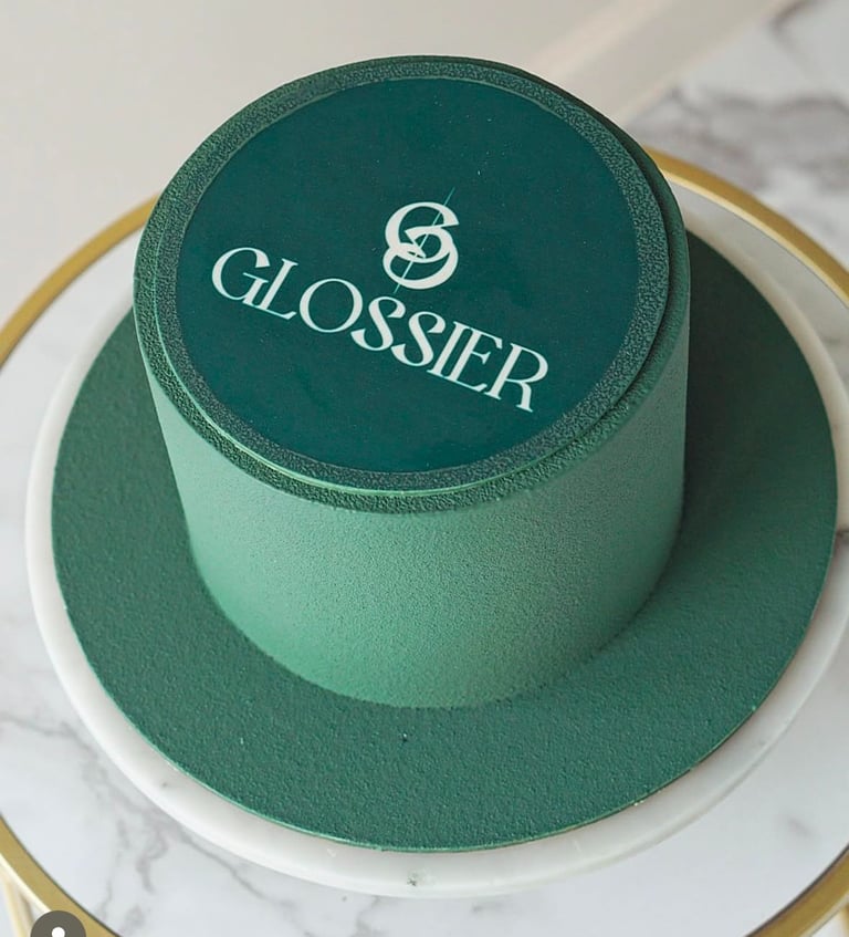a cake with a green hat on top of a table