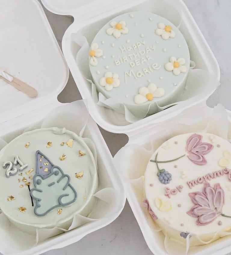 a birthday cake in a container with a unicorn birthday cake