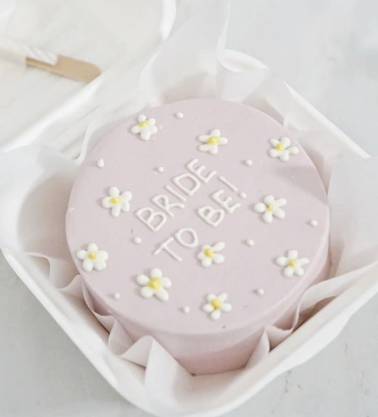 a cake with a bridesmaid cake topper