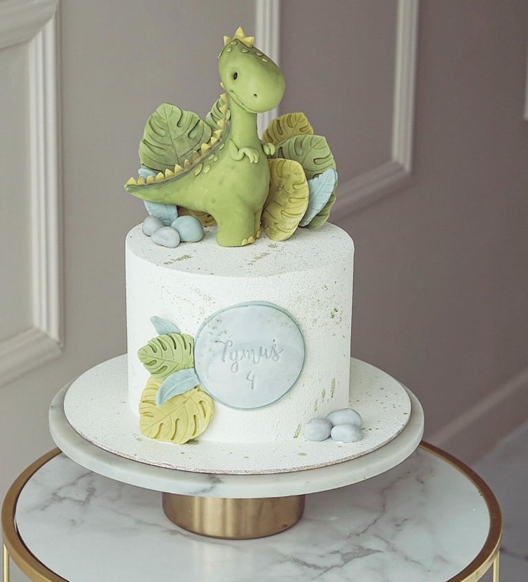 a cake with a dinosaur on top of a table