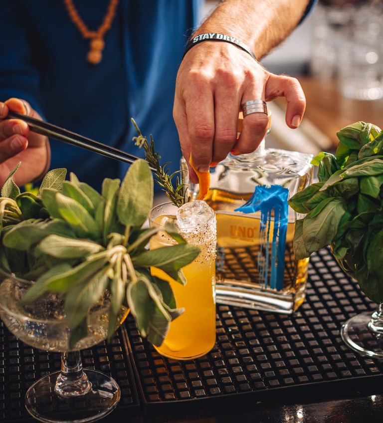 a man is preparing to make a tequila cocktail with a bottle of uno tequila añejo