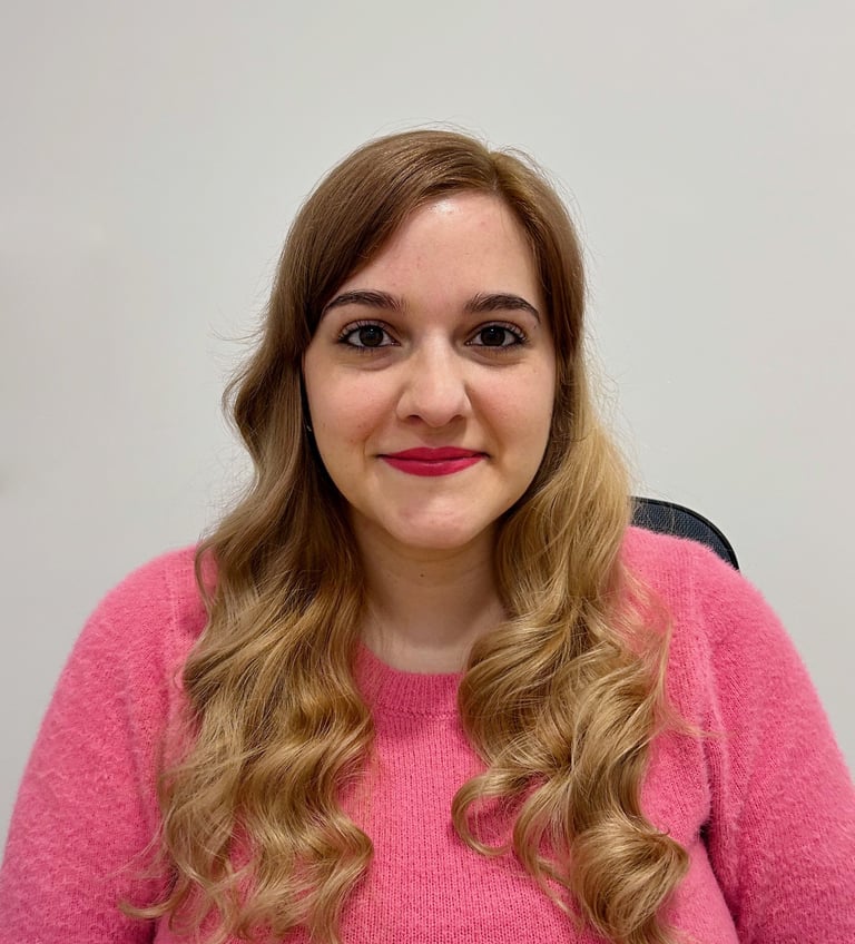 Fotografía de Fuencisla Martín. Mujer joven de pelo largo rubio, viste un jersey rosa
