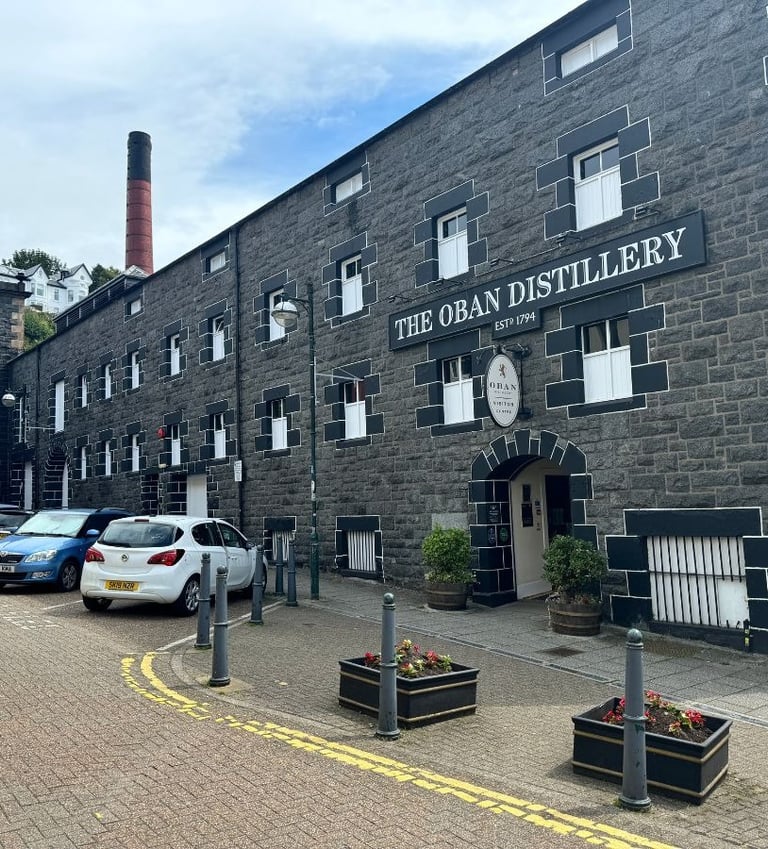 a brick building with cars parked in front