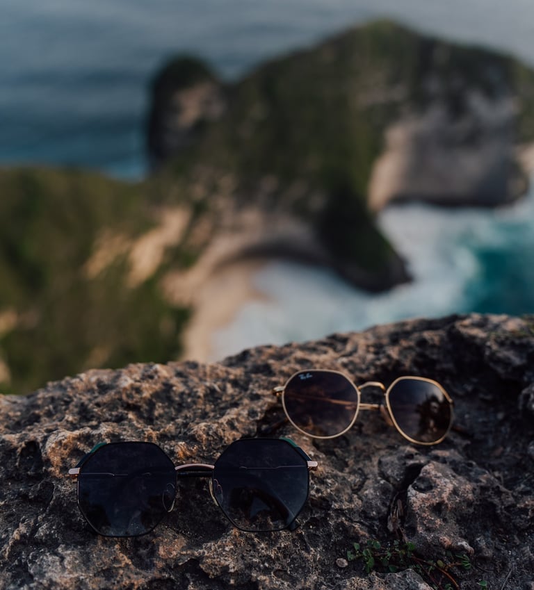 a pair of sunglasses and sunglasses on a rock