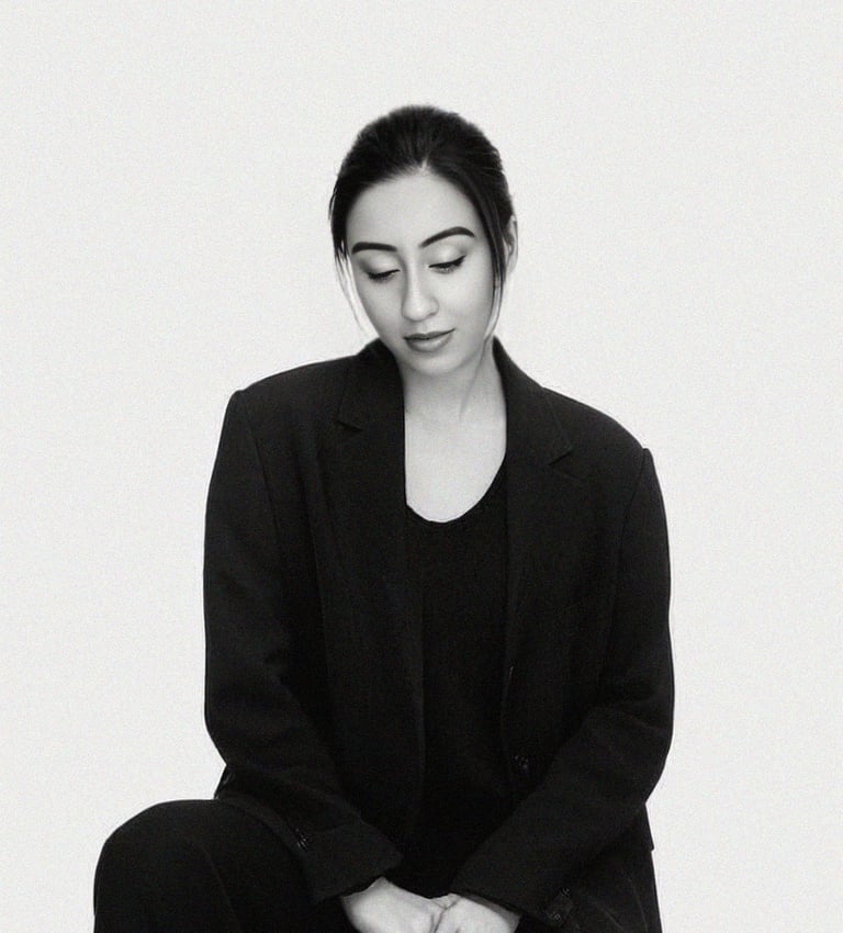 a wedding photoghrapher sitting on a stool with her eyes closed