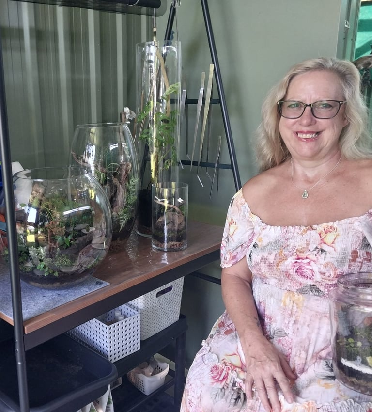 a woman in a floral dress sitting on a shelf