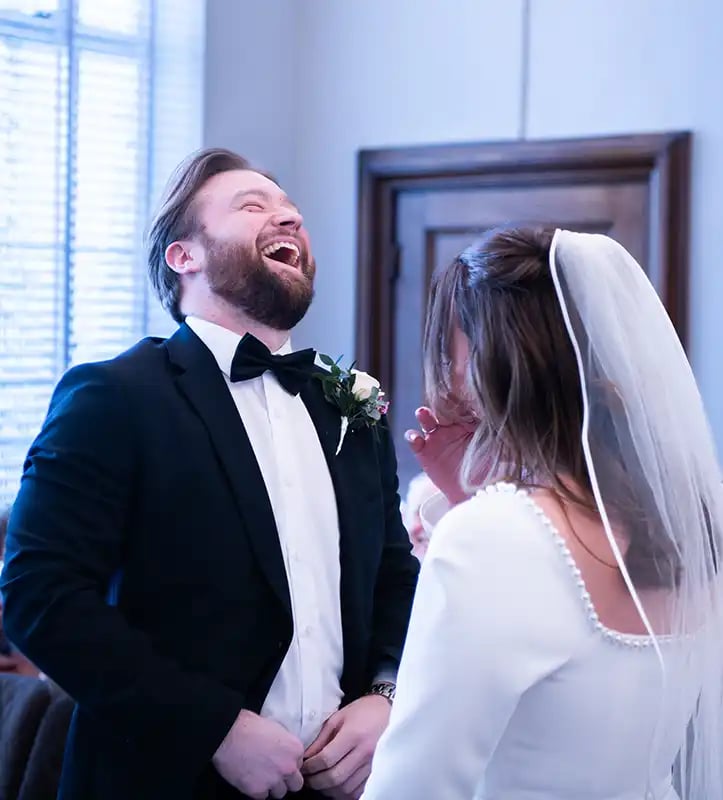 groom laughing during wedding ceremony at Islington Town Hall