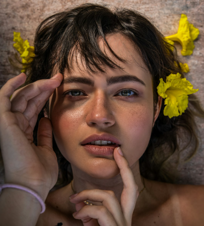 Close-up of a person with healthy, glowing skin, natural dewy texture, and a calm expression