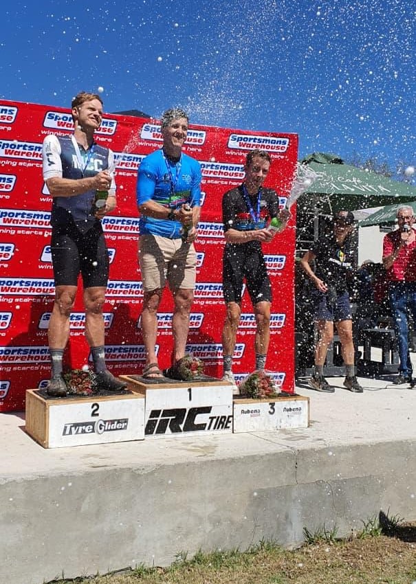 Cycling coach Andre on podium at Sportsmans Warehouse mountain bike race.