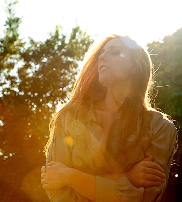 Layla Claire close-up portrait in golden sun light, artist branding shoot